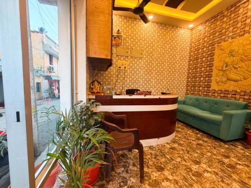 a lobby with a counter and a green couch at EESHA Beach View Stay - Near Temple and Beach in Rāmeswaram
