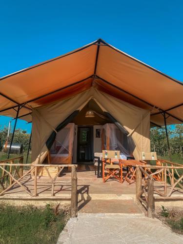 a large tent with tables and chairs in it at Emaamara camp in Narok