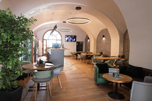 a restaurant with tables and chairs in a room at Rezidence Černý medvěd in Znojmo