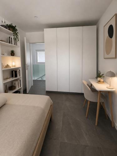 a bedroom with a bed and a desk and a table at Montebello in Bellinzona