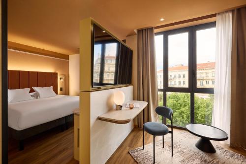 a hotel room with a bed and a mirror at You Hotel de France Valence - Handwritten Collection in Valence