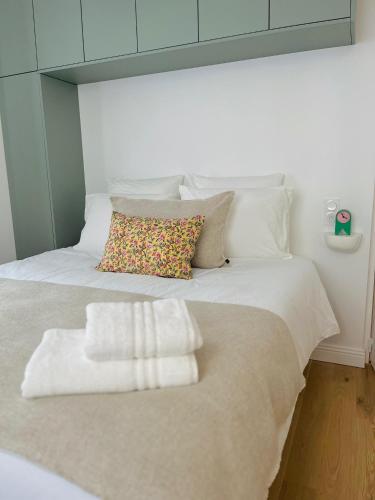 a bed with two towels sitting on top of it at La Maison Kerguelen - Suite in Quimper