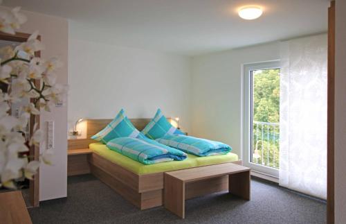 a room with a couch with pillows and a window at Apartments Am Grafenberg in Grafenberg