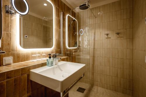 a bathroom with a sink and a mirror at Corner Hotel in Stockholm