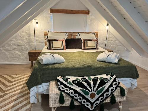a bedroom with a large bed in a attic at Casa do Encanto in Terra Alta