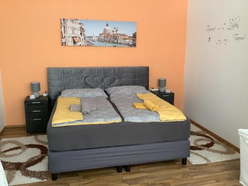 a bedroom with a bed with yellow pillows on it at Ferienwohnung Casa Flora in Pamhagen