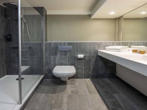 a bathroom with a toilet and a sink and a shower at ibis Beaune Centre in Beaune