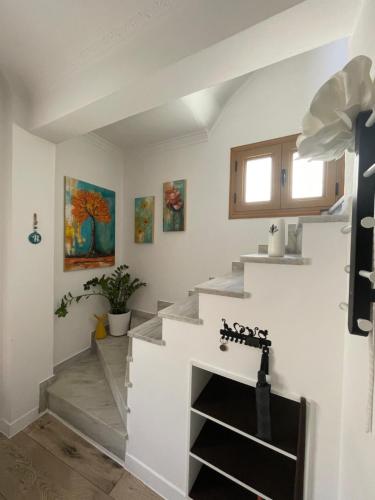a staircase in a home with white walls at MonJa puhkemaja in Marathokampos