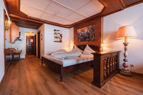 a bedroom with a bed and a lamp in it at Hotel Jagdhaus Monzabon in Lech am Arlberg