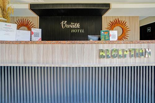a counter with a hotel sign on top of it at Collection O Bwalk Hotel Malang in Malang