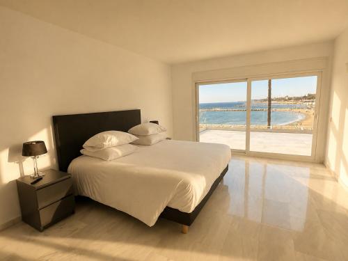 a bedroom with a bed with a view of the ocean at B51 Executive Flats Marbella in Marbella