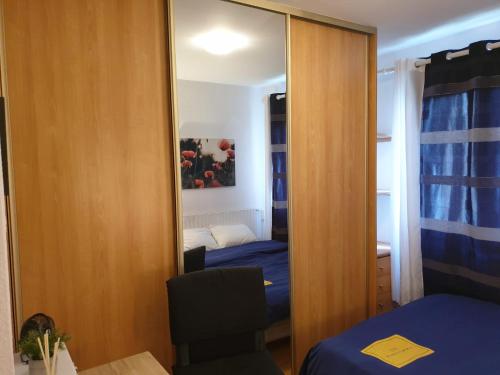 a mirror in a room with a bed and a bedroom at Cozy Private Room -5 mins from CERN -Shared Apartment in Saint-Genis-Pouilly