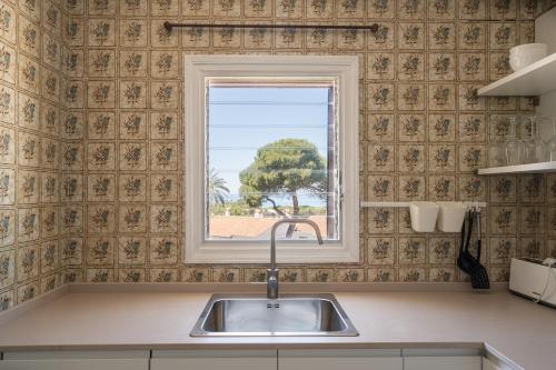 a kitchen with a sink and a window at V110B Villa La Pau in Son Bou