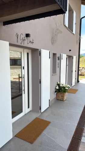 a building with doors and a sign that reads i gift drive at Maso K - Il Gufo Dorato in Folgaria