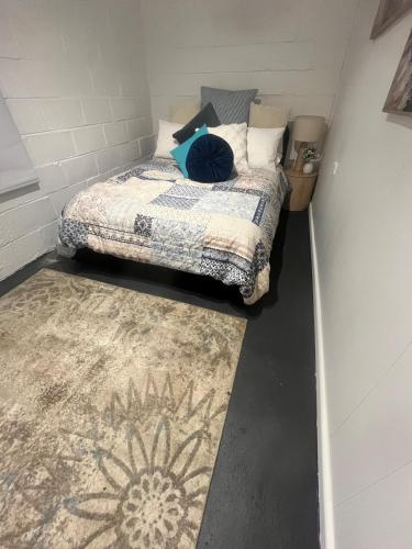 a small bedroom with a bed and a rug at Olivers Home in Forbes