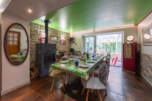 a dining room with a table and a fireplace at Gîte Du Ruisseau avec spa et pêche in Épinal