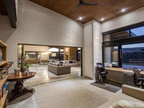 a large living room with a barber chair and a salon at Heaven's Door Main House in Stilbaai