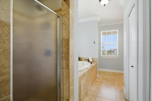 a bathroom with a shower and a sink at Periwinkle Paradise in Navarre