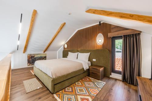 a bedroom with a bed and a large window at Muraga Villas by PikHost in Tirana