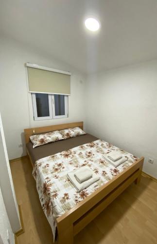 a bedroom with a large bed in a room at Rena Comfort Apartment in Bar