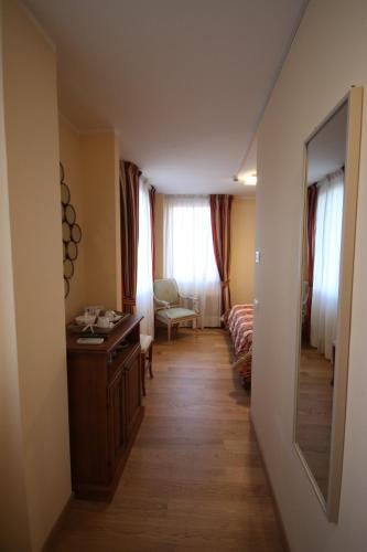 a hallway with a room with a desk and a chair at Hotel Italia in Sacile