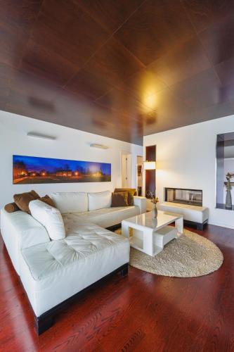 a living room with a white couch and a table at Ladanjsko Imanje Principovac in Ilok