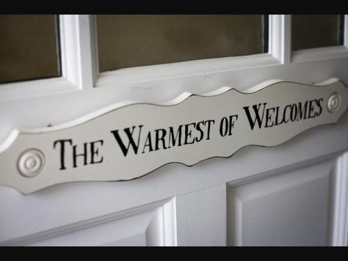 a sign on a door that reads the wandest ofdoors at Y Garth B&B in Newport