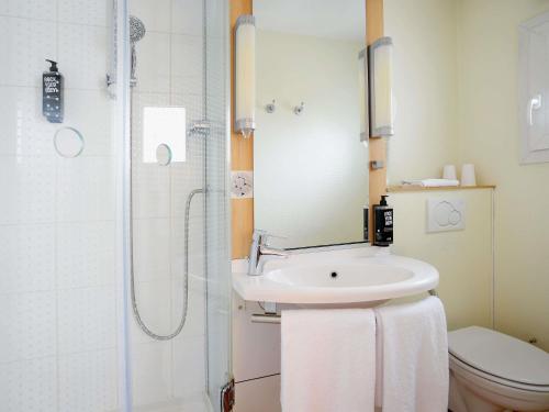 a bathroom with a sink and a shower and a toilet at ibis Toulouse Centre in Toulouse