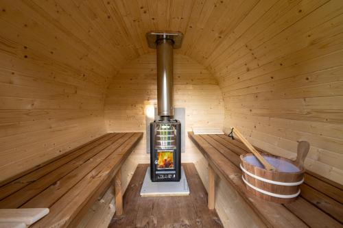 a inside of a sauna with a wood stove at Jurta pod Blaníkem s wellnes in Chotýšany