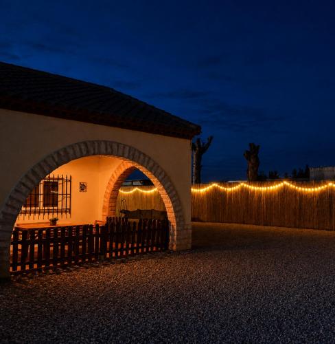 a building with a fence with lights on it at Finca Sueño Crea in Lorca