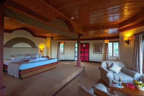 a bedroom with a bed and a living room at Nature Haven Mara Camp in Ololaimutiek