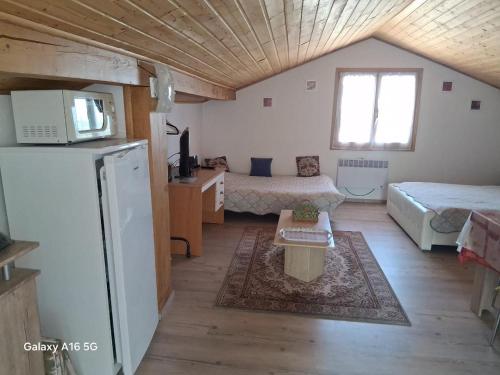 a small room with two beds and a refrigerator at Appartement Nicole BENKOVAC in Benkovac