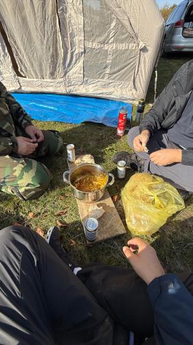 a group of people sitting in front of a tent at Bosnian Nature Glamping in SJJ