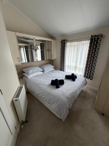 a bedroom with a large bed with two towels on it at Sunnyside Lodge in Dunning Station