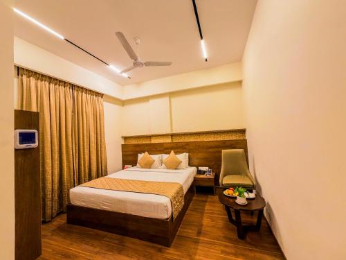 a hotel room with a bed and a table at Zip By Spree Hotels Brookefield in Bangalore
