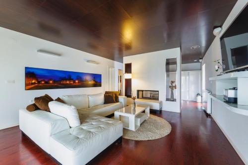 a living room with a white couch and a table at Ladanjsko Imanje Principovac in Ilok