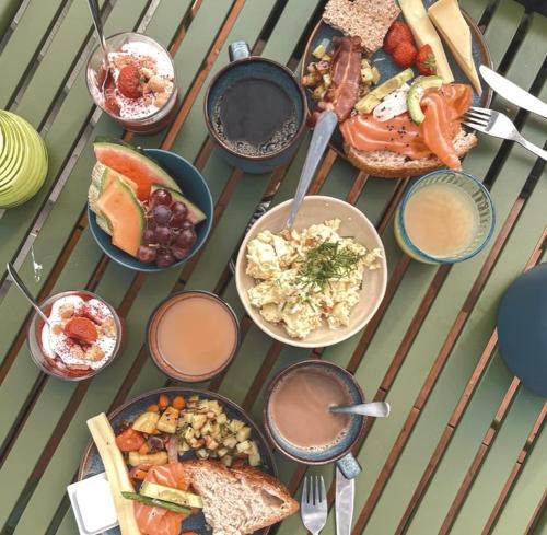 a table with many different plates of food on it at Klippen Hotel - Skt Jørgens Gaard in Gudhjem