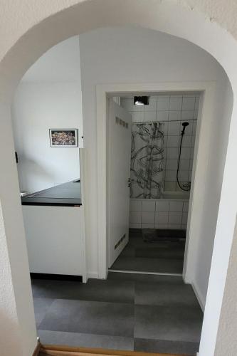 a room with a bathroom with a sink and a mirror at Privileg - NewTime in Viersen