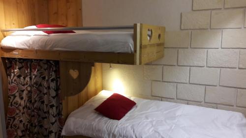 a couple of bunk beds in a room at Hôtel Du Midi in Thônes