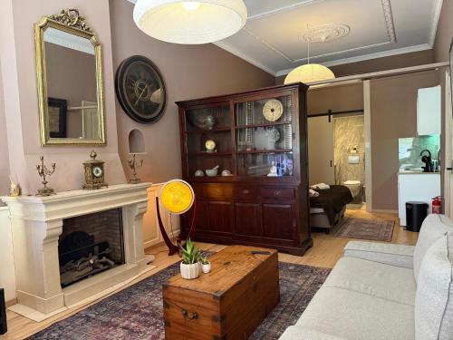 a living room with a fireplace and a mirror at Grachtenpracht Boutique in Breda