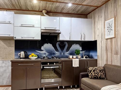 a kitchen with white cabinets and a stove at Dostoievski 2 ROOM in Bălţi