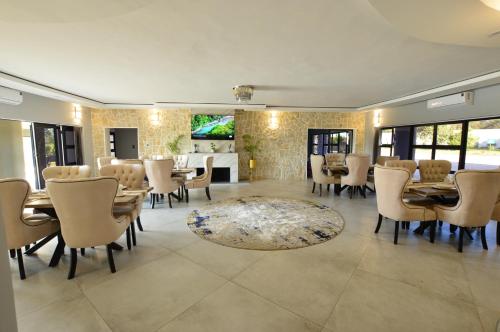 a dining room with a table and chairs at Sparrow Boutique Hotel in Bulawayo