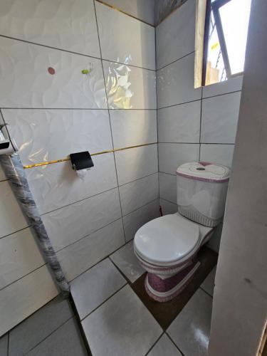 a small bathroom with a toilet in a stall at Turfloop guest house in Ga-Mothapo