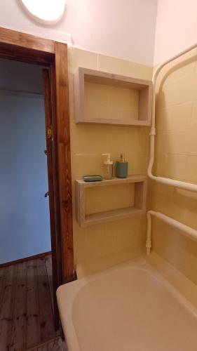 a small bathroom with a tub and a sink at Light street in Ķekava