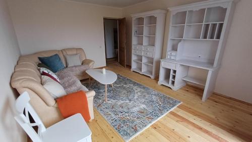 a living room with a couch and a table at Light street in Ķekava