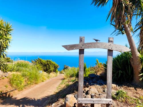 a sign on the side of a trail near the ocean at El Jaral in Garafía
