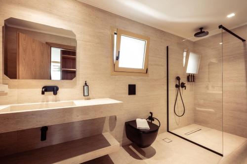 a bathroom with a toilet and a sink and a shower at Callisto Azzure in Zakynthos