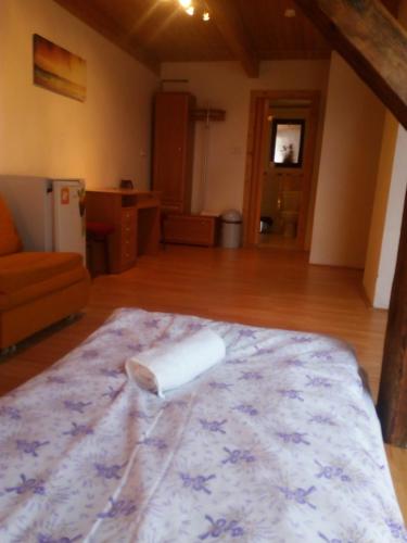 a room with a bed with a pillow on it at Penzion U Slunce in Jaroměř