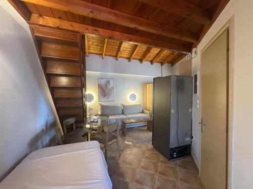 a bedroom with a bed and a table and a couch at Mersea standard apartment Kourouta in Kourouta