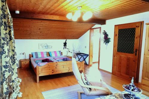 a living room with a bed and a chair in it at Fischer Willi in Bad Koetzting